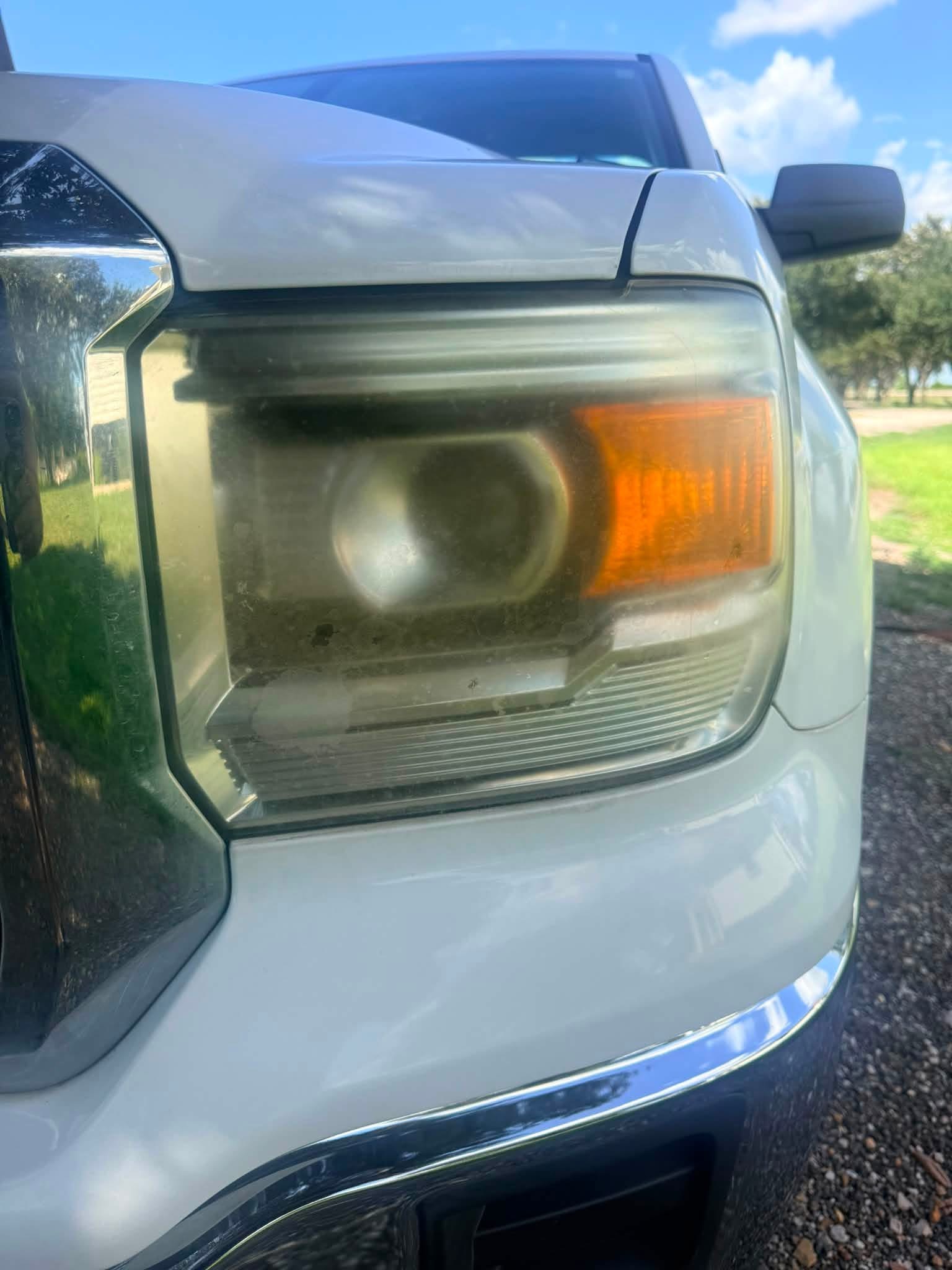 Cloudy headlight before Soapy Dreams headlight restoration