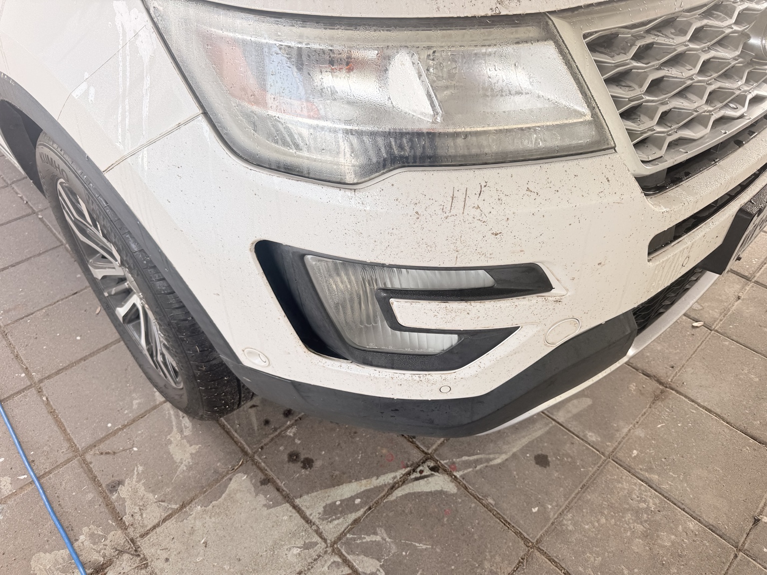 White SUV before paint protection film removal
